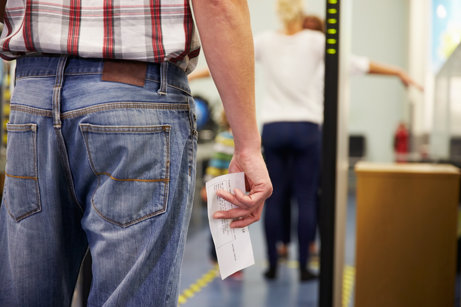 a man holding an airplane ticket at the airport