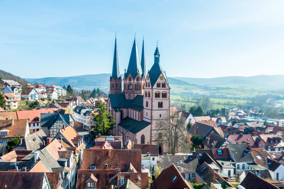 Cityscape of Gdansk showing hills in the background and the church  in the foreground.
