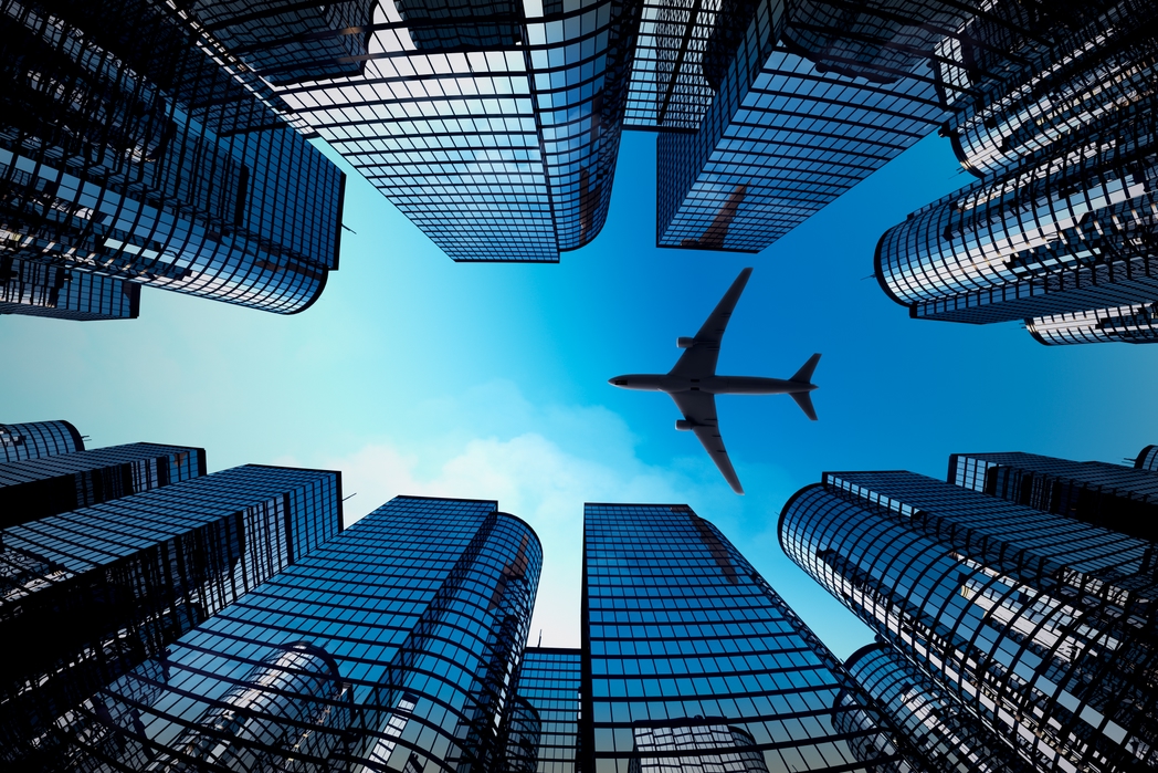 Plane flying amidst skyscrapers