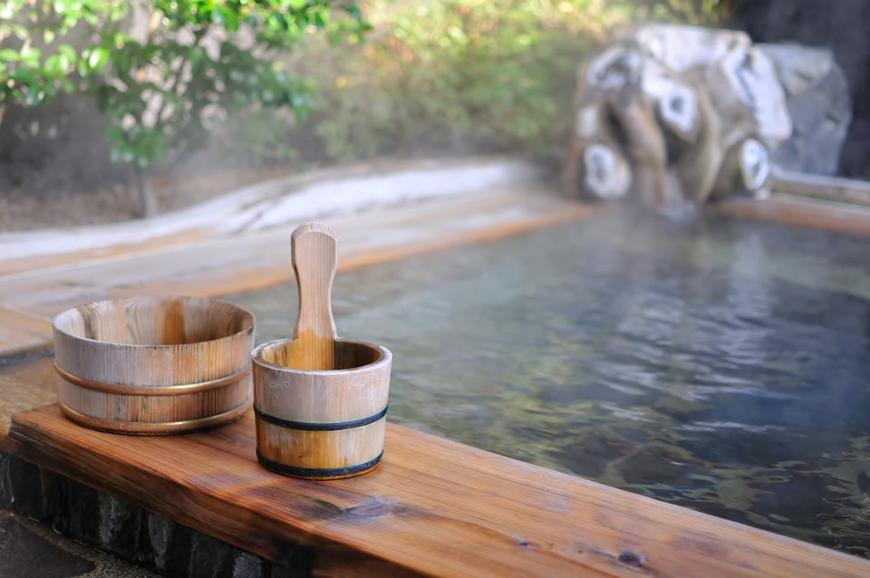 hot water pool and wooden bowls at a ryokan in Japan