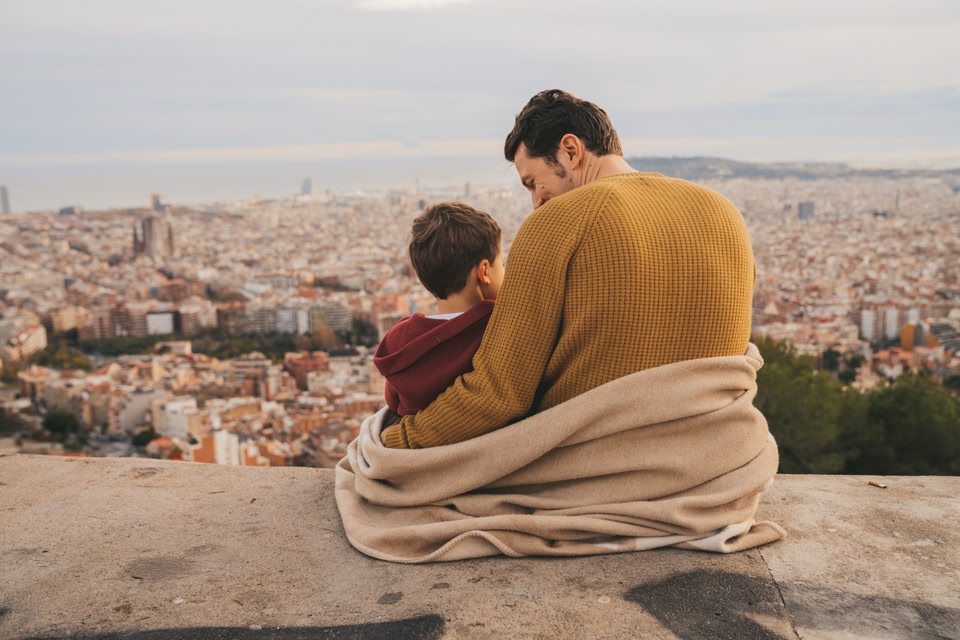 Family looking at Barcelona cityscape.