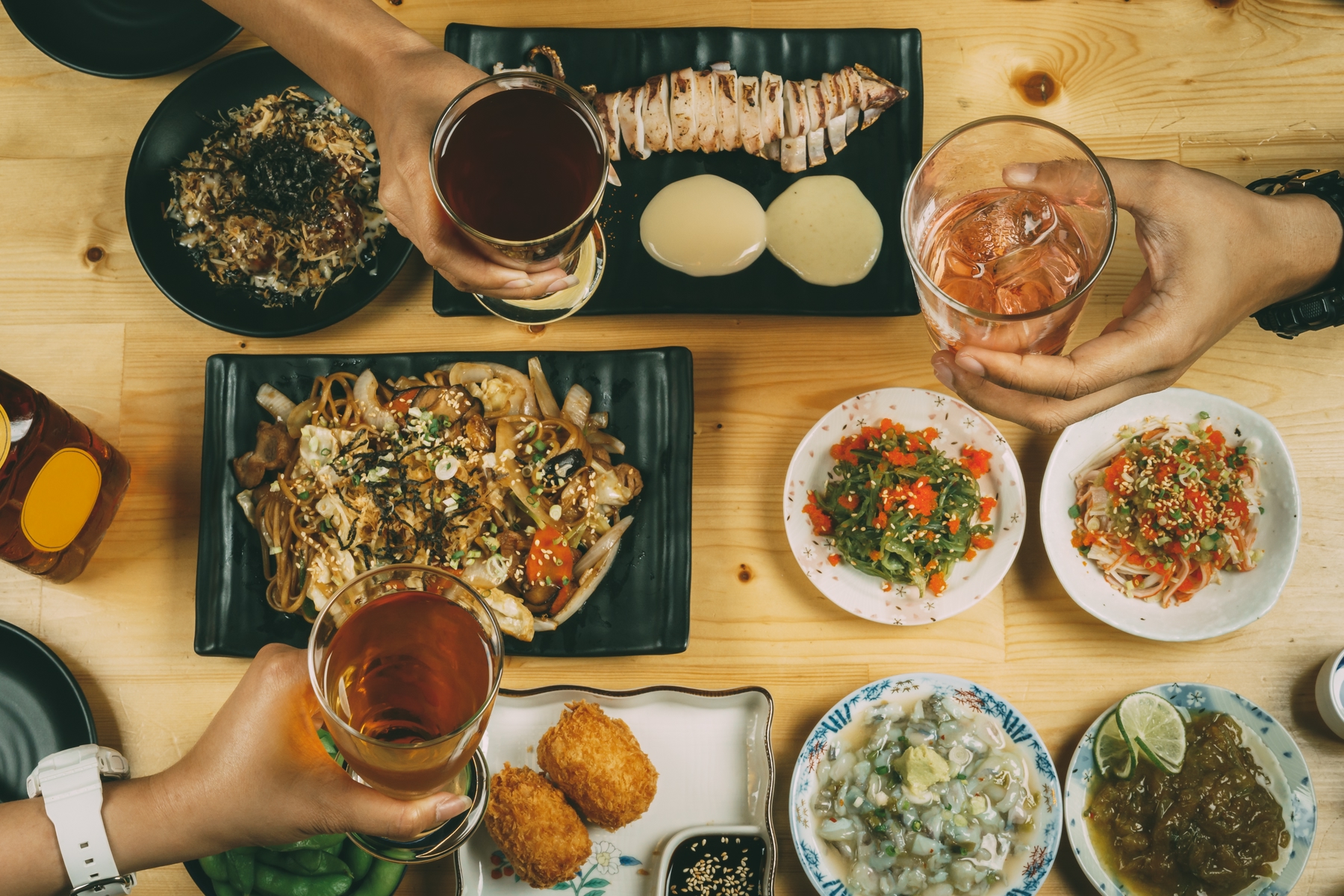 a table with several different plates of food and drinks made by planning a trip a year in advance