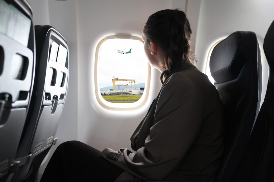 Person looking out plane window