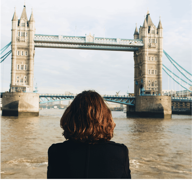 A woman enjoying the scenic view of London Bridge from afar