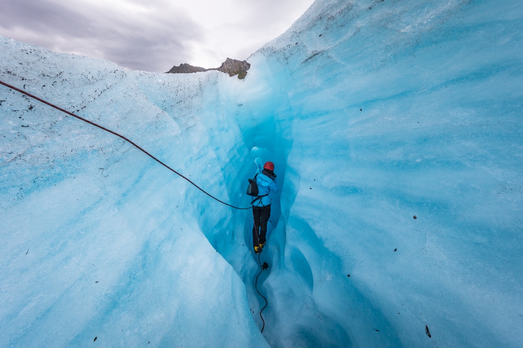 Traveller exploring an iceberg
