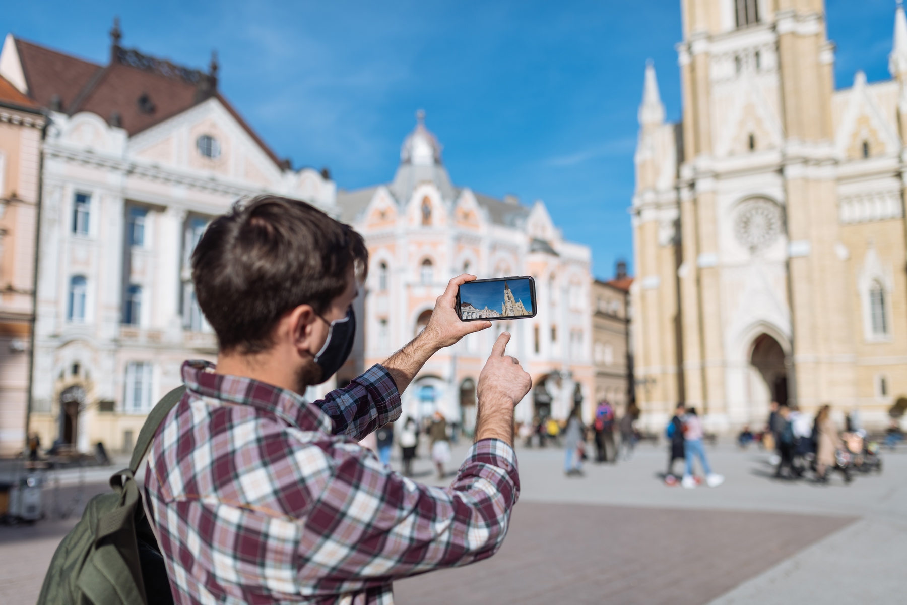 Young male tourist in the historical district of City of Novi Sad, Serbia, Eastern Europe