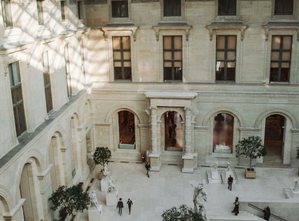 an image of few people walking in a white building