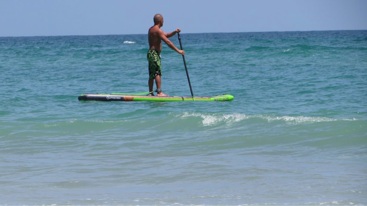 Ein Mann betreibt Stand-up-Paddling im Meer bei Tag.