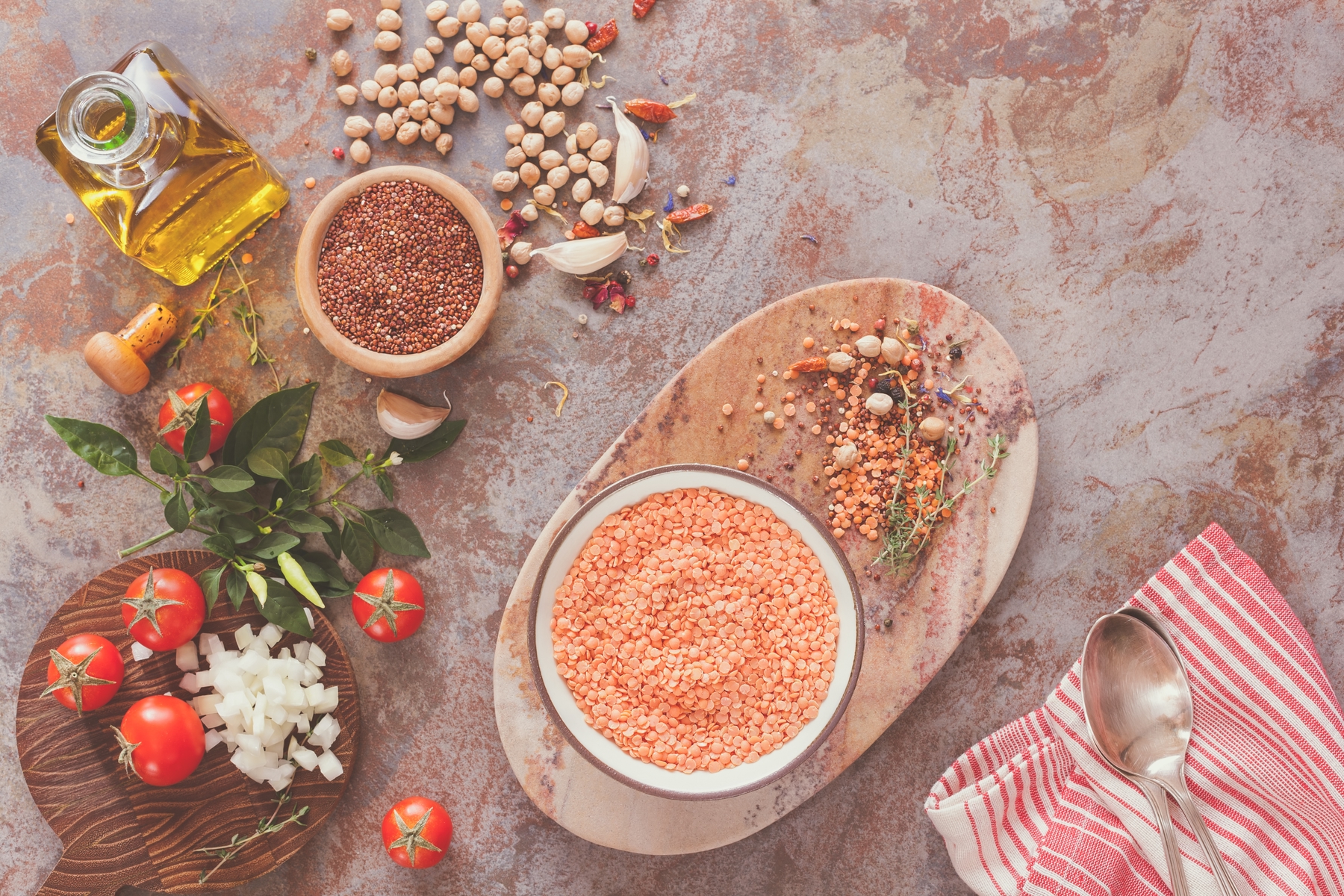 plate of red lentils with tomatoes and condiments on the side