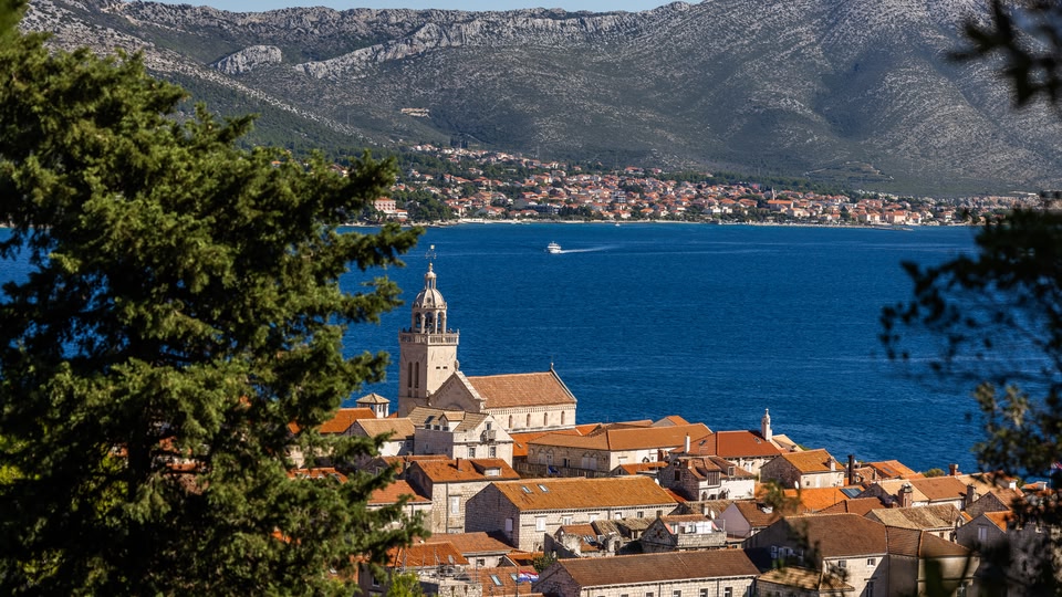 Long shot of Korcula town with the sea in the background