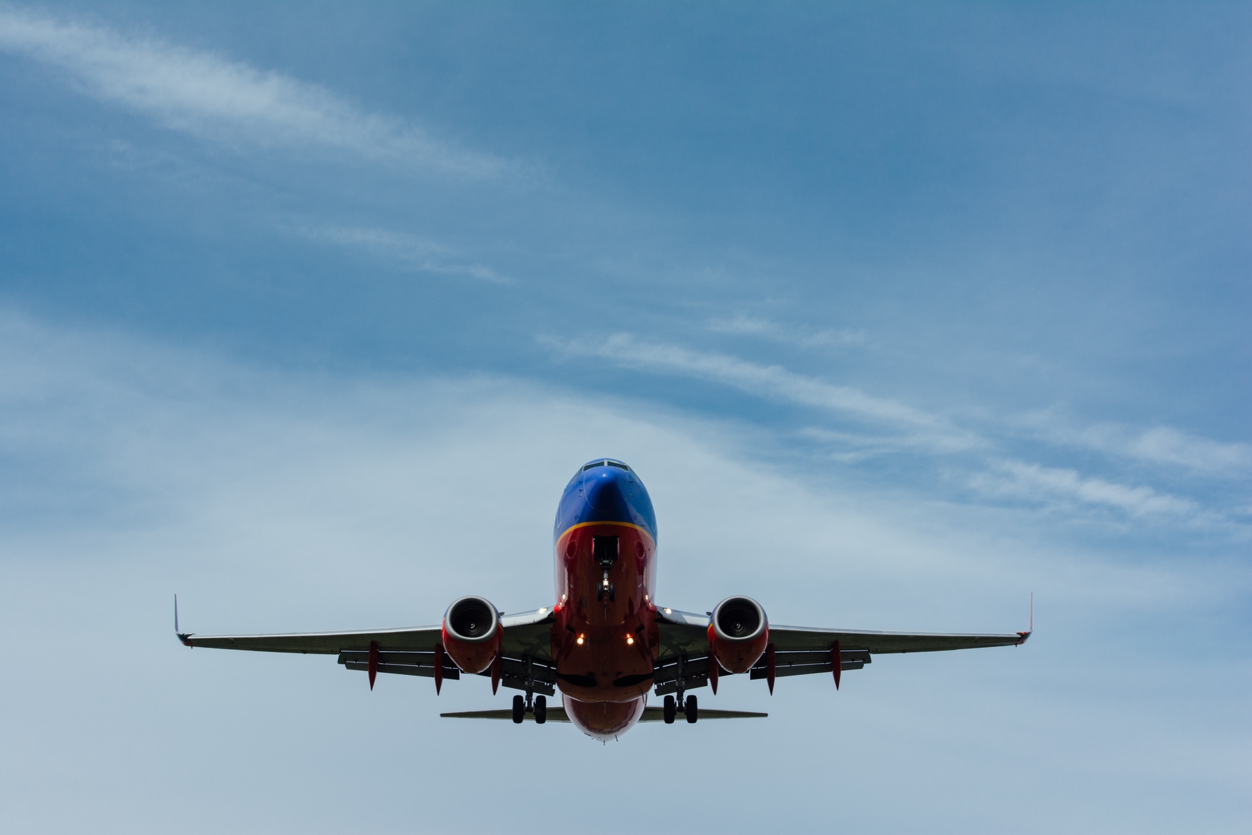 A plane flying. Flight delays and cancellations are par the course lately. Find out what your rights are with Skyscanner.