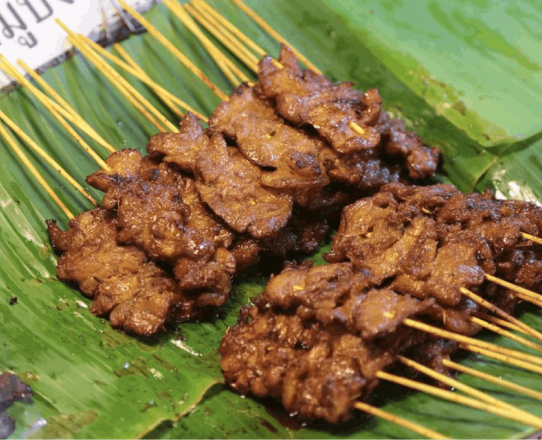 An enticing shot of some delicious Thai kebabs, showcasing a vibrant array of perfectly grilled skewers