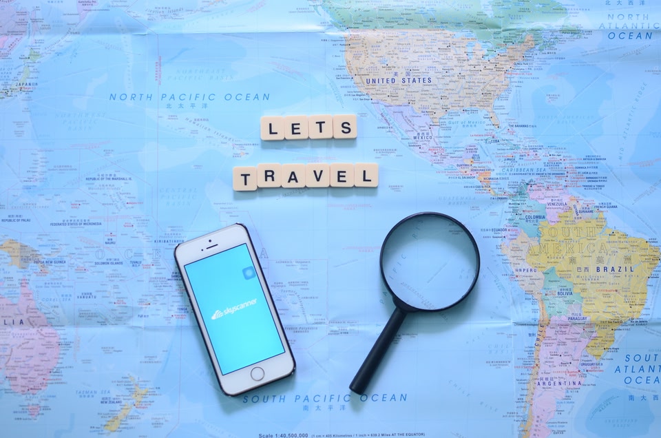 map with smartphone and looking glass