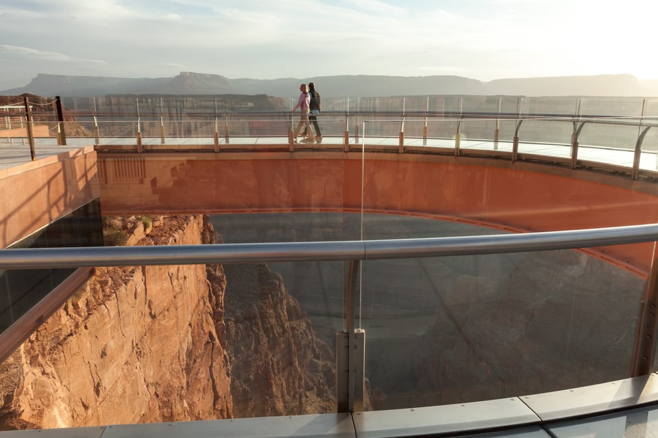 Photo of two people walking across the Grand Canyon Skywalk