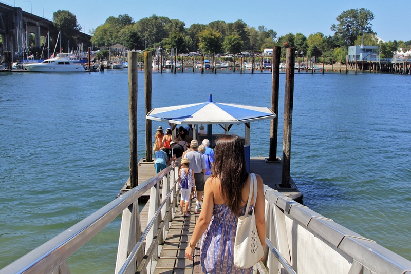 woman walking towards a dock on the water in Vancouver