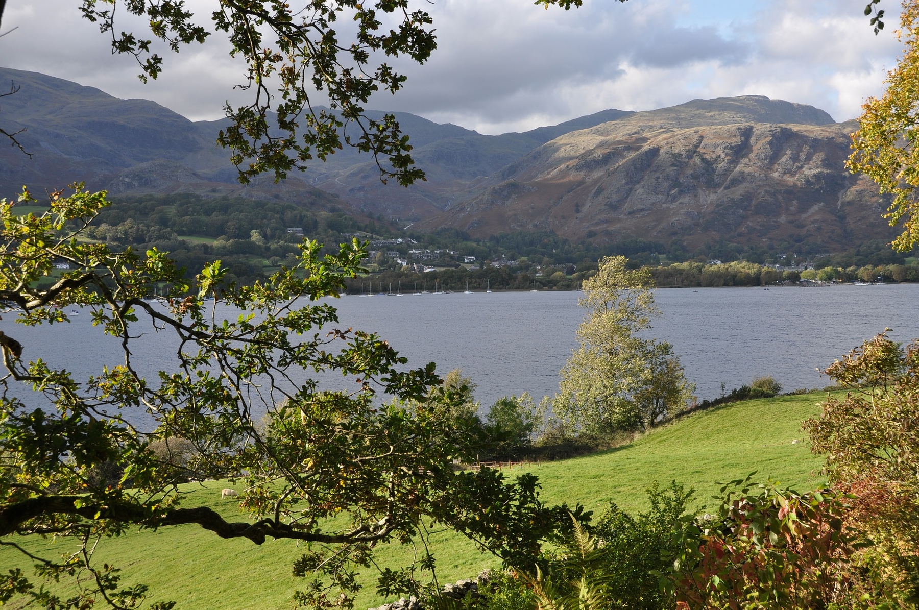Coniston Water, a lake surrounded by mountains and trees in the Lake District