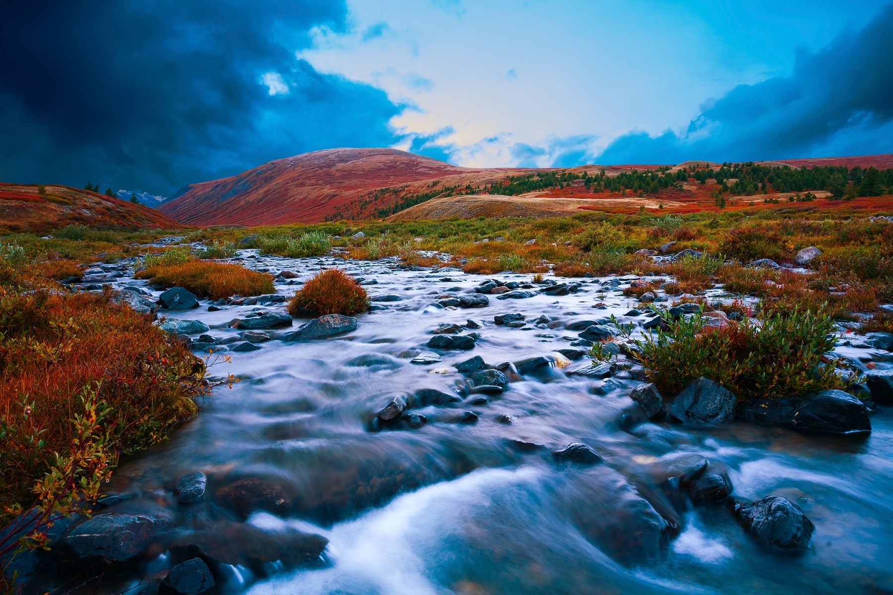 fast flowing water through orange desert landscape