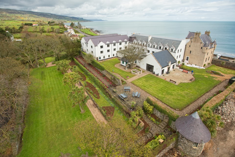 Ballygally Castle exterior with sea in background