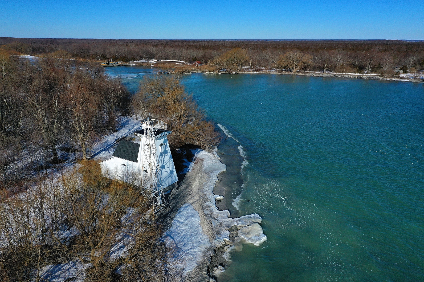 shoreline of Lake Ontario in Prince Edward County with a lighthouse, on a winter's day