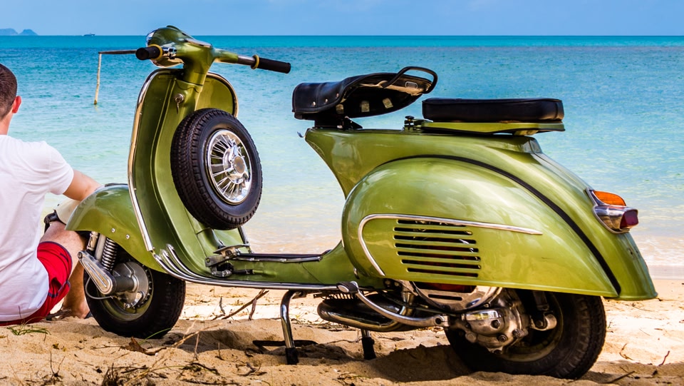An image of a moped on the beach 