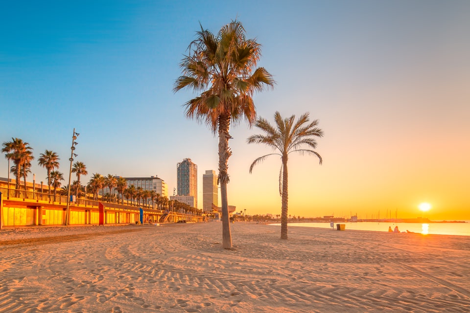Barceloneta Beach in Barcelona with colorful sky at sunrise