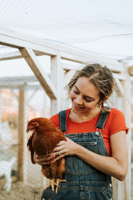 Woman holding her pet chicken
