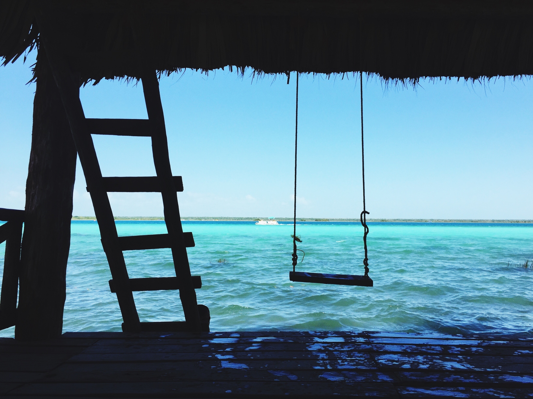 empty swing above water