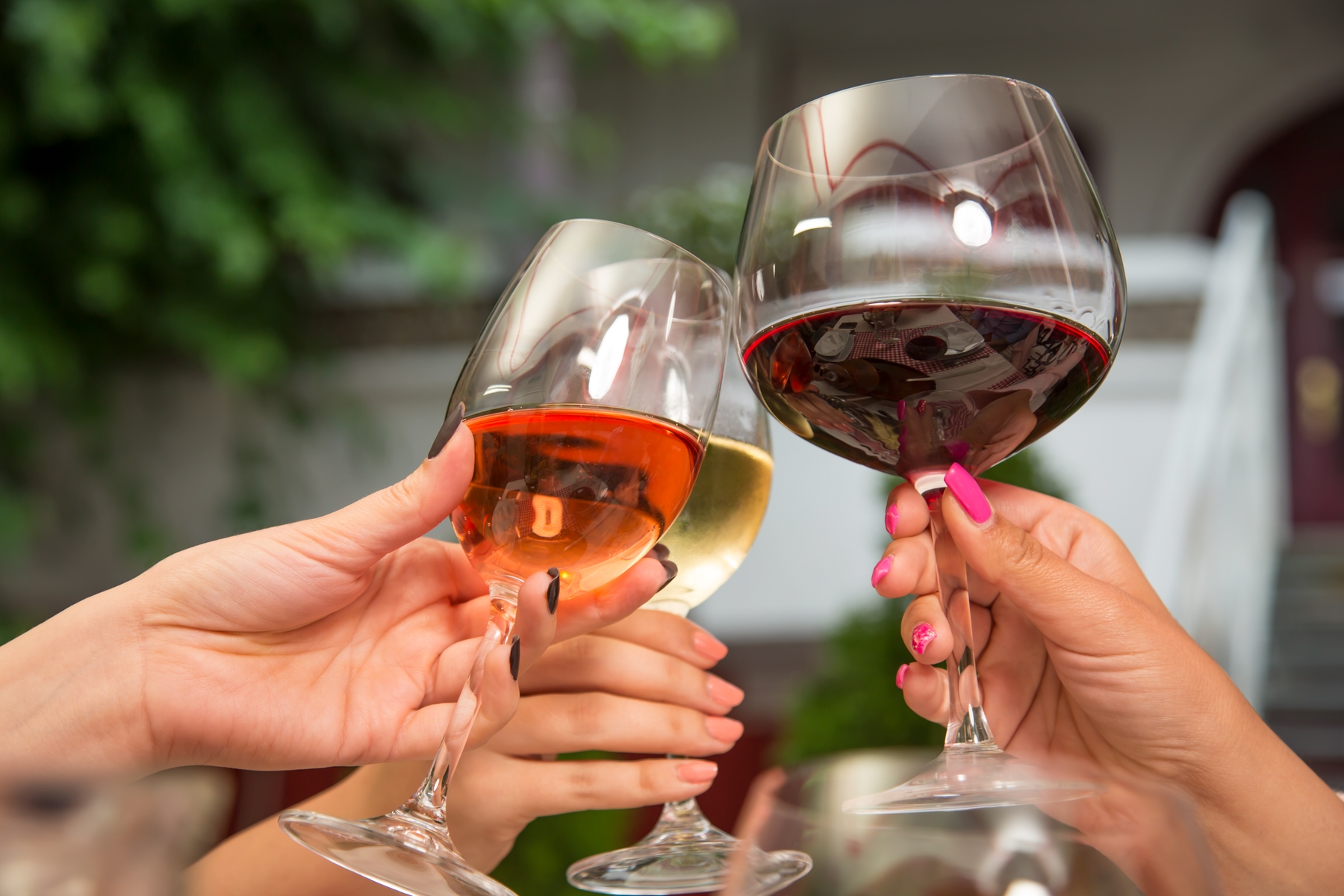 friends clinking wine glasses