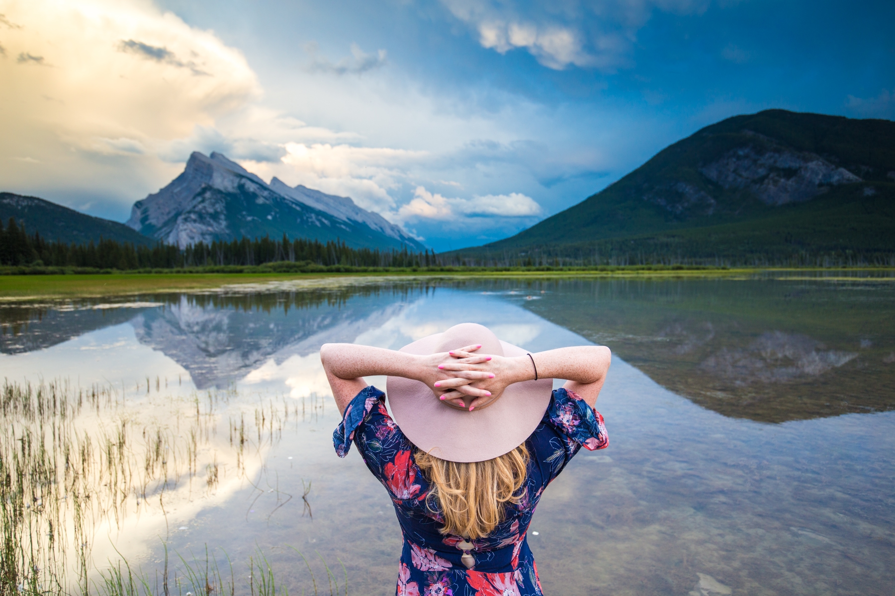A woman looking out at a landscape in Canada, one of the best places to travel alone.