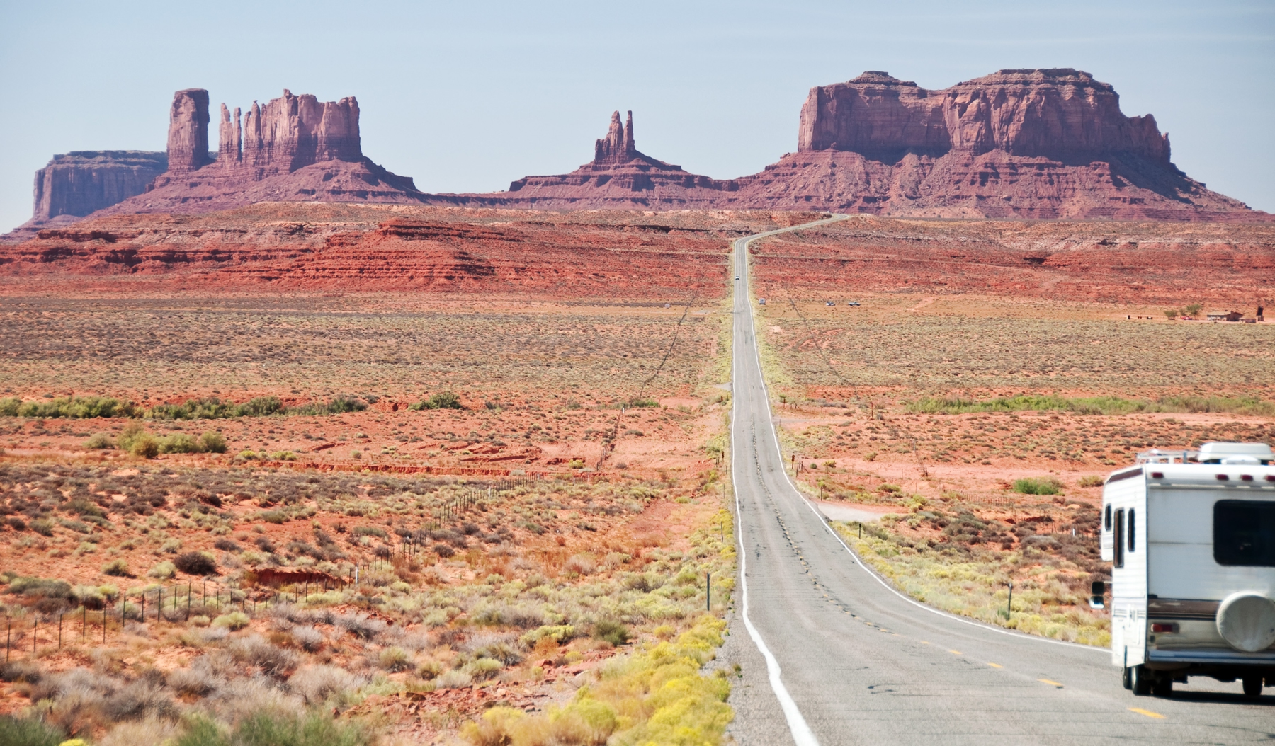RV traveling down a road in Monument Valley
