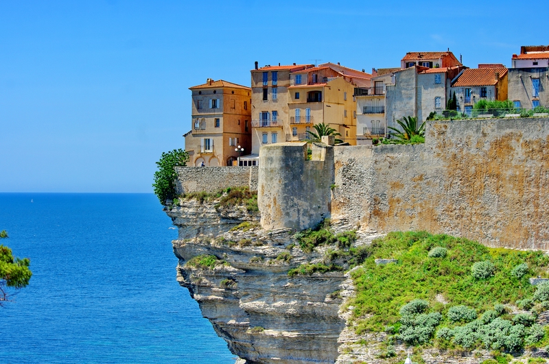 Houses perched on a cliff in Corsica, France - May sun holidays