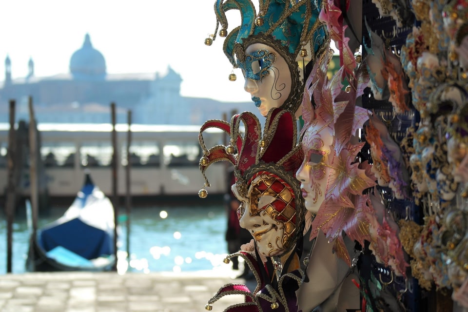 masks displayed near the canal in Venice, Italy during the day