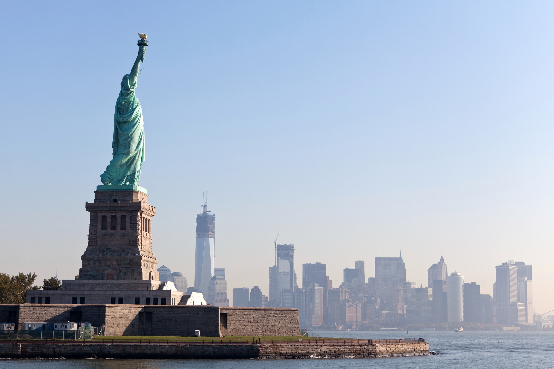 View of Manhattan's skyline with the Statue of Liberty in the foreground.