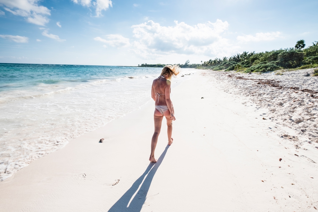 Woman on the beach in Tulum - 10 cheap holiday destinations around the world