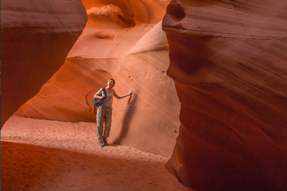 Person in walking through red cave