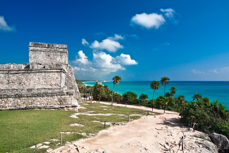 Ruins at Tulum with turquoise waters and palms trees