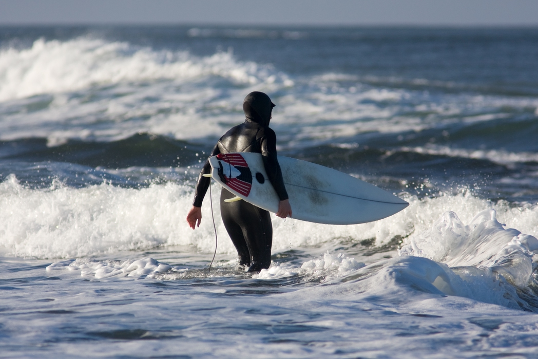 Surfer getting into the water in Bundoran