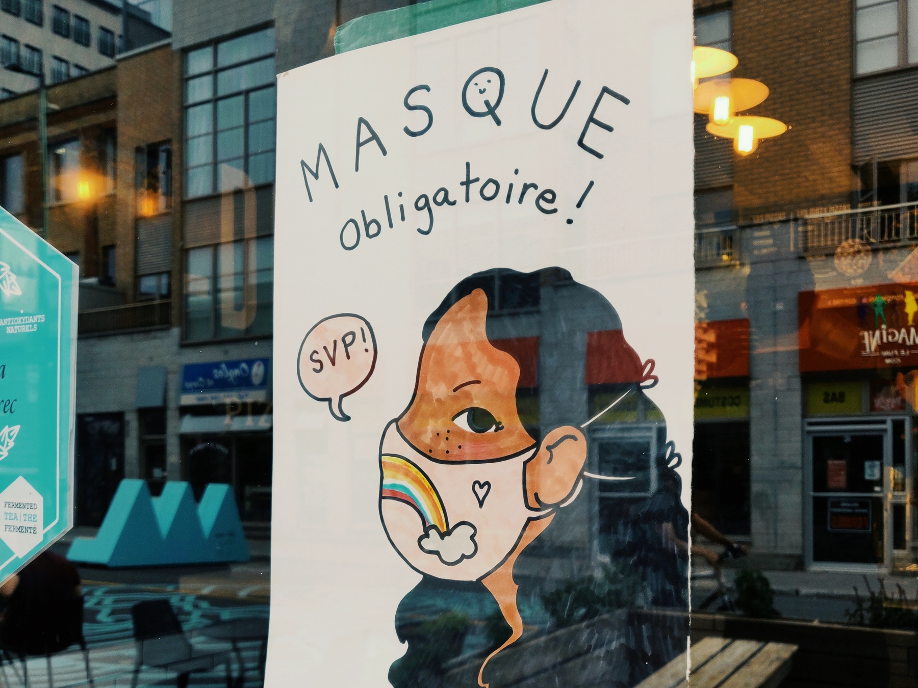 masks mandatory sign in a window front in Montreal