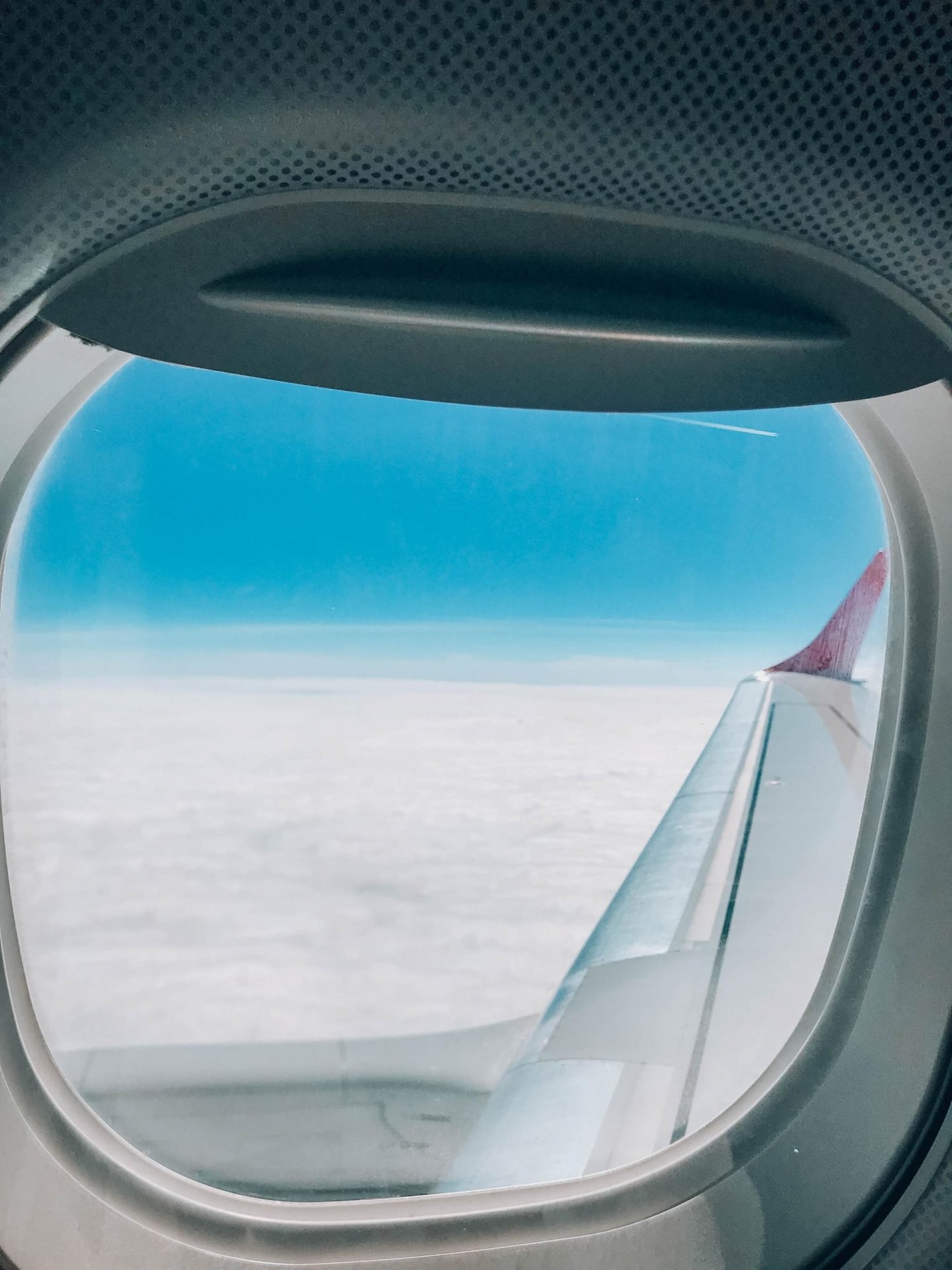 Airplane window, flying during covid-19 coronavirus
