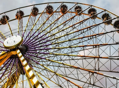 A low angle shot of a Ferris wheel
