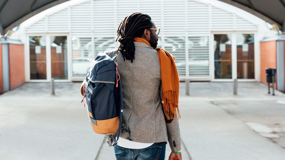 man walking into an airport