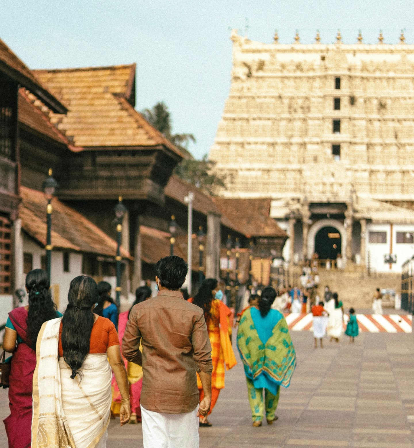 Group of people walking toward a Hindu temple in Thiruvananthapuram, south India.