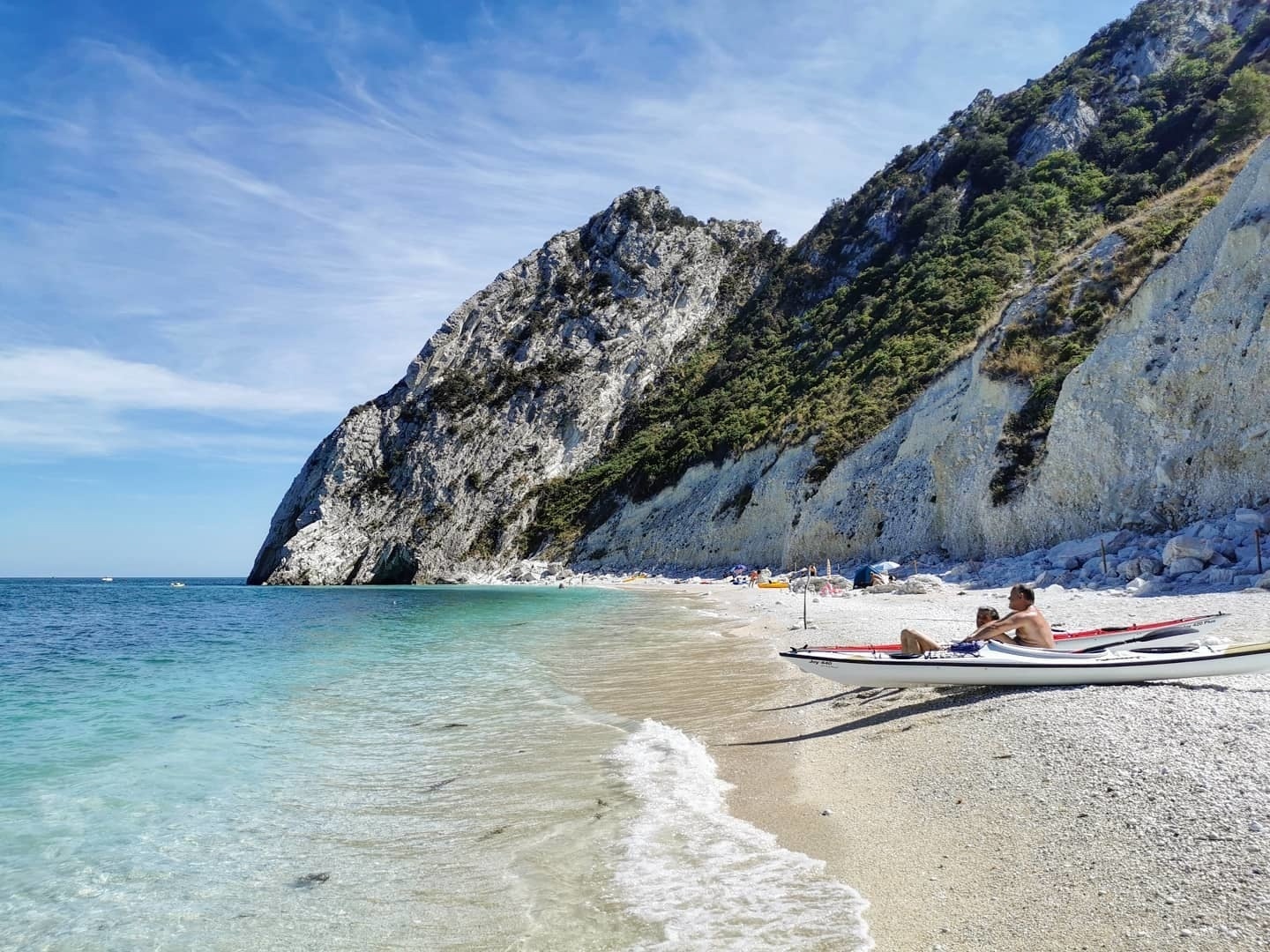 A boat sits on the shores of Spiagga Delle Due Sorelle in Le Marche, Italy. 