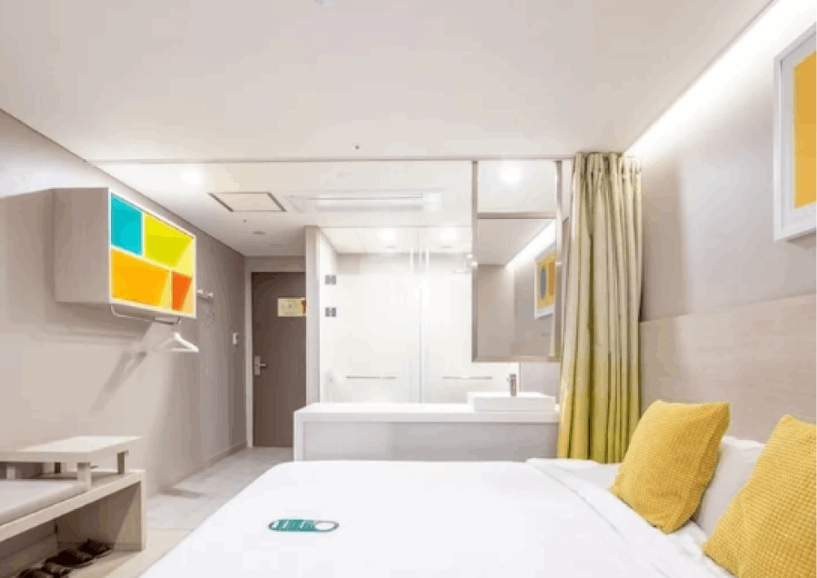 Interior view of a vibrant room at the new Seoul Hotel Myeong-dong. Colorful decor complements a comfortable double bed, creating an inviting and cheerful ambiance.