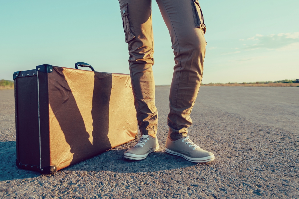 Man travelling with a vintage suitcase - weekend getaways in Ireland