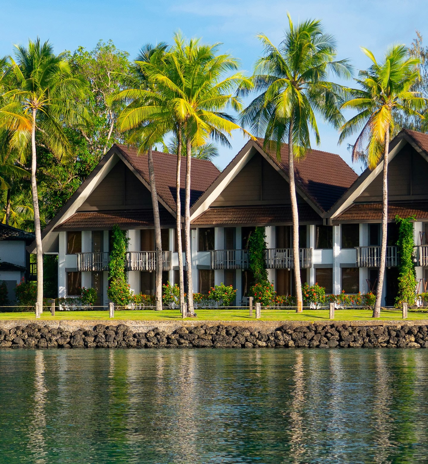 Palm trees and lakeside houses overlooking the water in Koror, Palau