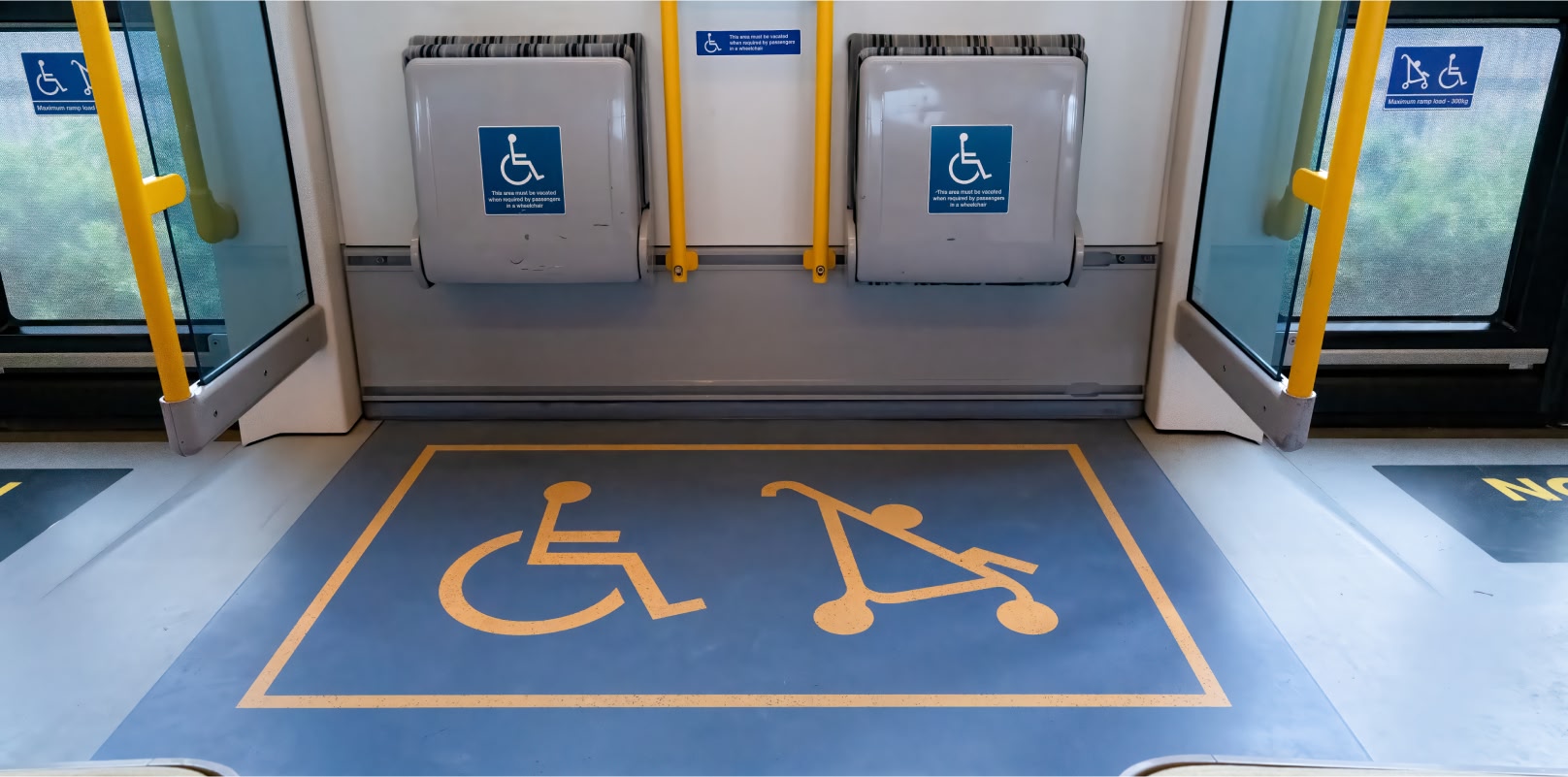 Image showing a train carriage with a space for wheelchair users to sit.