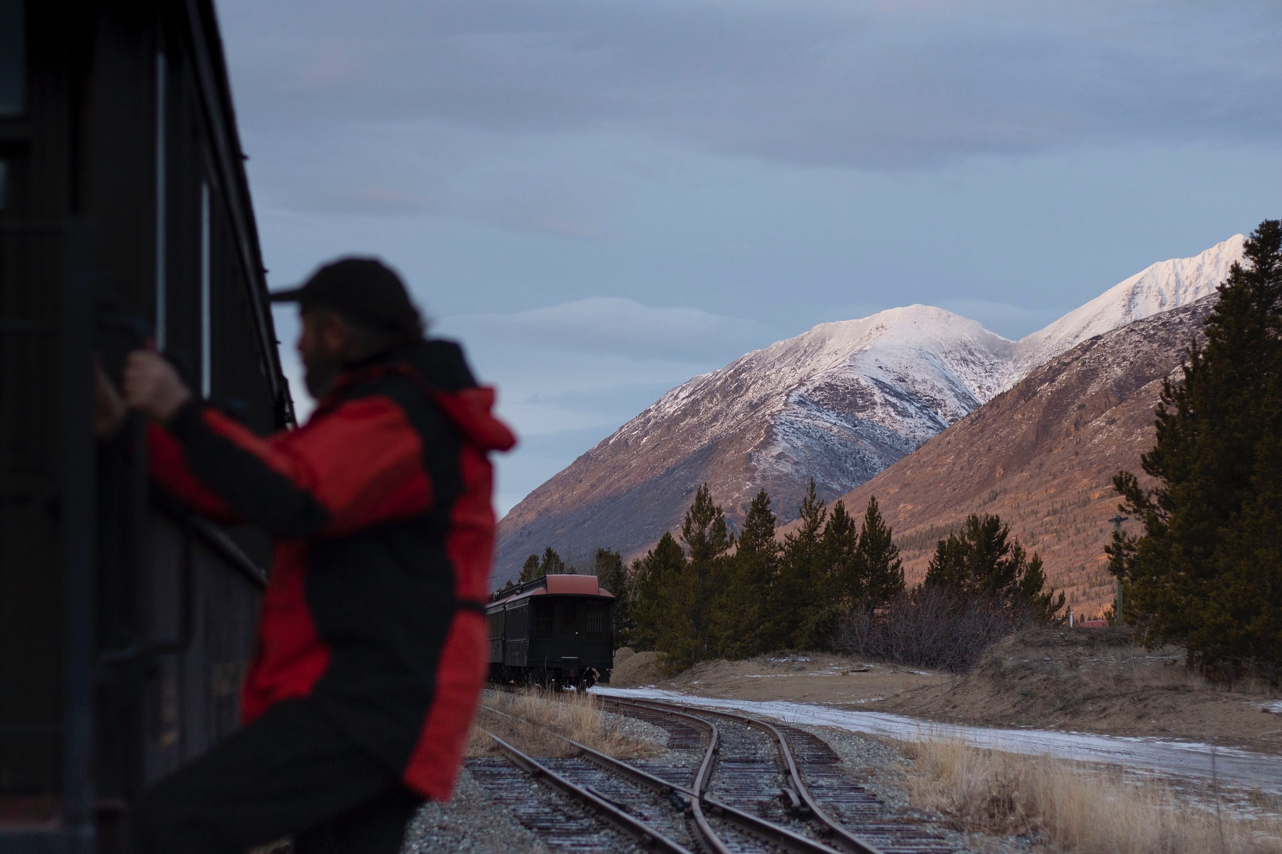 man outside of a train in Carcross, Yukon