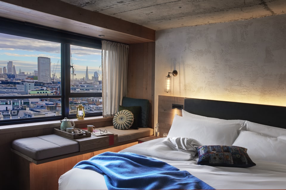 Bedroom at Treehouse Hotel London, boasting views across the city.