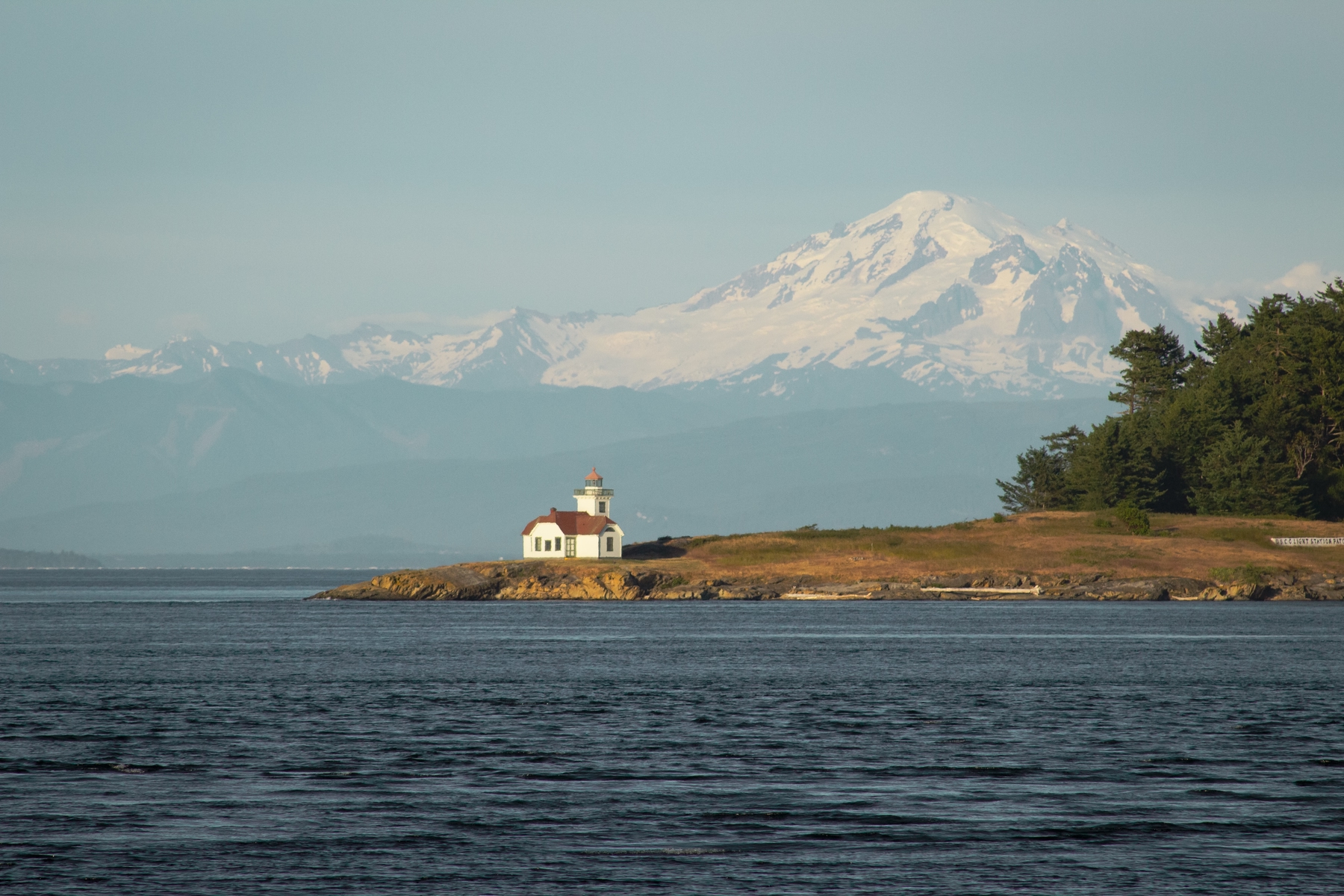 A white lighthouse on the coastline of the Northwest USA